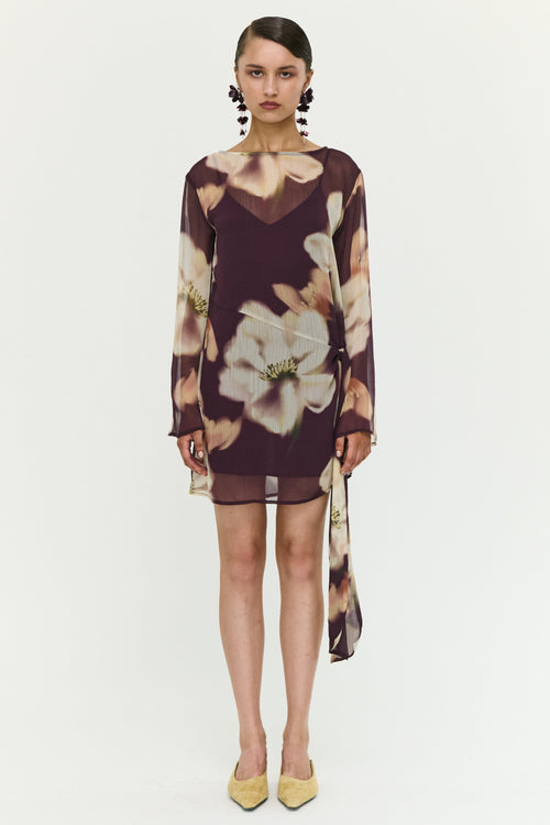 Woman wearing a floral dress on a white background