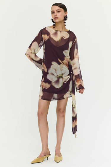 Woman wearing a floral dress on a white background