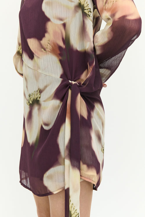 Floral patterned dress with a knot detail on a white background