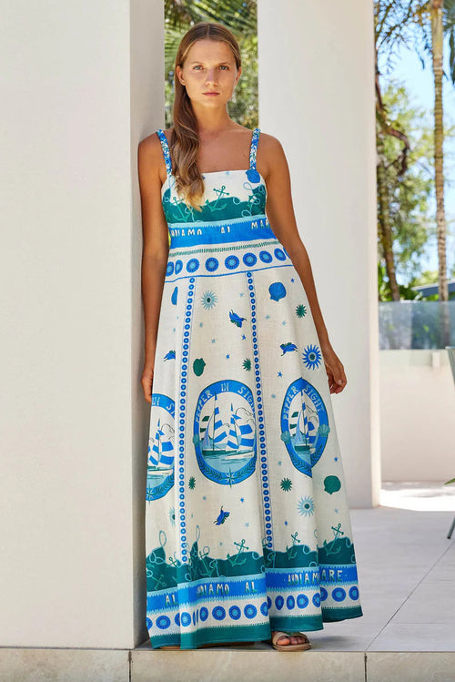 Woman wears a colourful blue strappy maxi dress