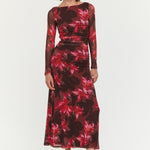 Model wearing a floral dress with long sleeves on a white background