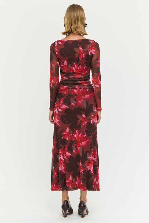 Woman wearing a red floral dress on a white background