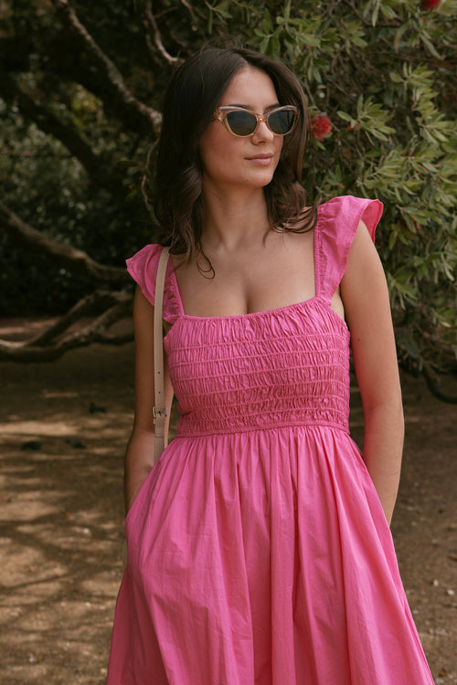 model wears long pink midi dress.