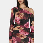 Woman wearing a floral one-shoulder dress on a white background