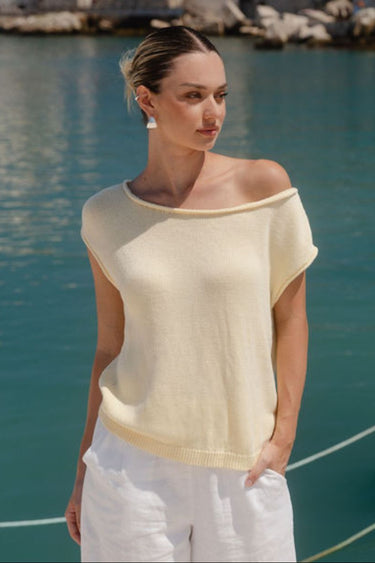 Woman wearing butter yellow knit top