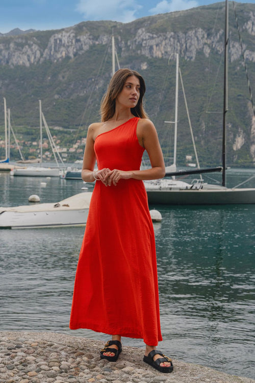 model wears a one shoulder red maxi dress