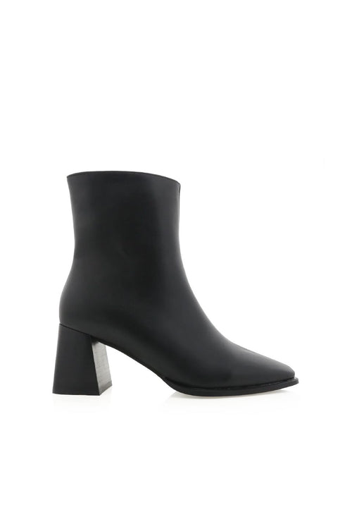 Black ankle boot with a block heel on a white background