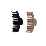 Two hair clips, one black and one beige, on a white background