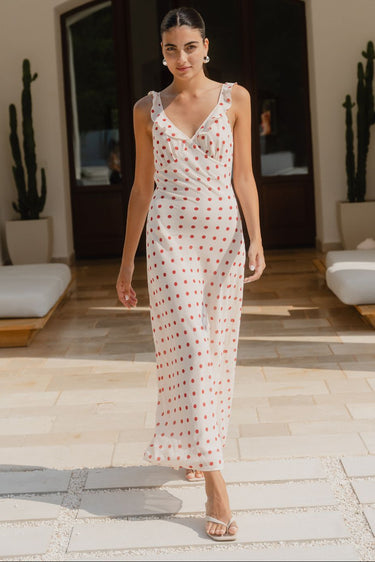Woman wearing a cream red polka dot dress