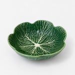 A green ceramic bowl shaped like a leaf, featuring a detailed embossed leaf vein pattern on the interior, set against a plain light gray background.