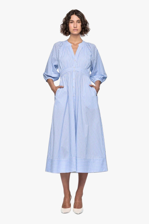 woman wearing a blue and white striped midi shirt dress