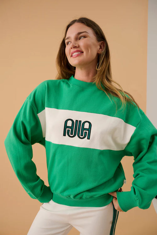 green and white sweater with text on front