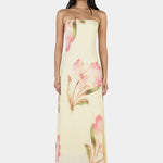 Woman wearing a strapless floral dress on a white background