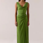 Woman wearing a green dress against a plain background