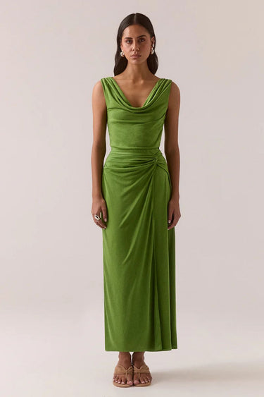 Woman wearing a green dress against a plain background