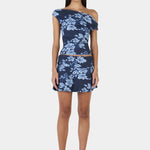 Woman wears a navy blue floral top and skirt