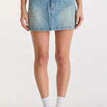 Woman wearing a blue denim mini skirt