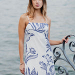 model wears a white and blue floral midi dress