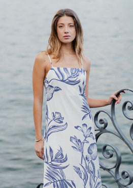 model wears a white and blue floral midi dress