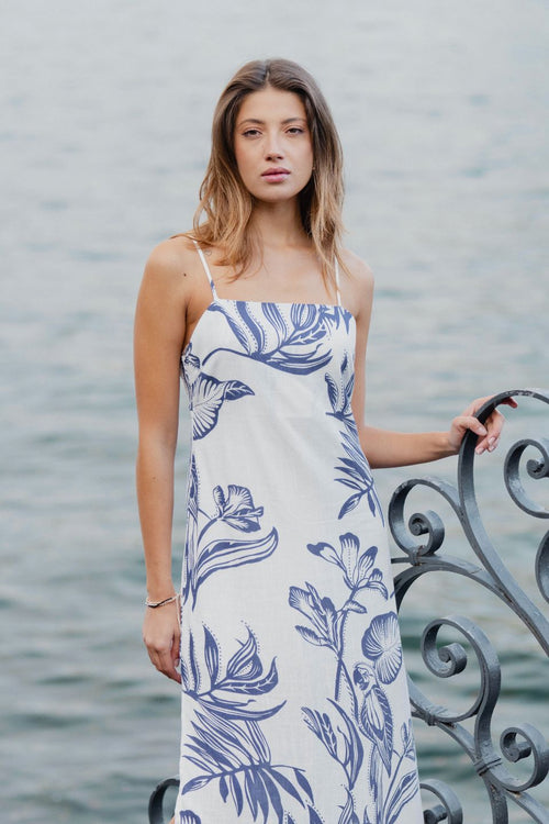 model wears a white and blue floral midi dress