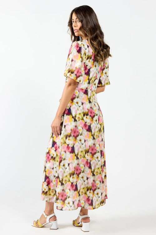 model wears a pink floral maxi dress