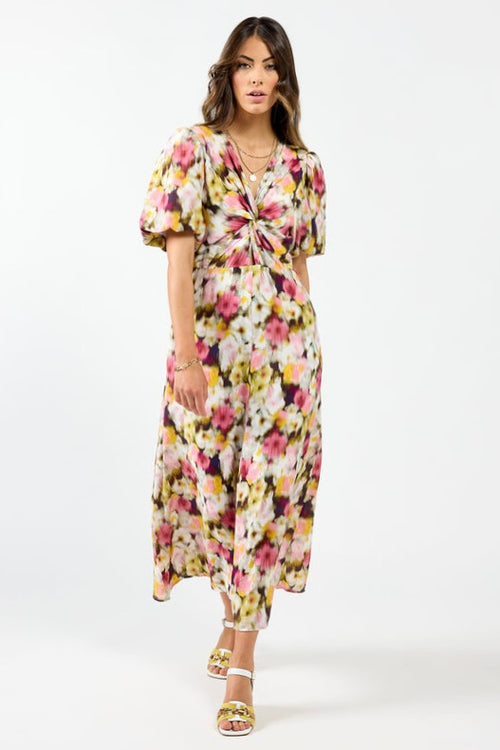 model wears a pink floral maxi dress