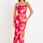 Woman wearing a pink floral dress on a white background