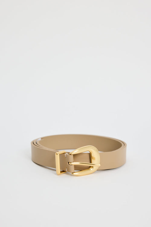 Beige belt with a gold buckle on a light gray background