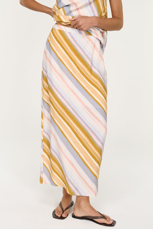 Woman wearing a striped dress with a white background