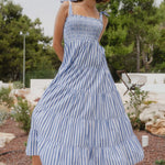Woman wears a blue white stripe dress