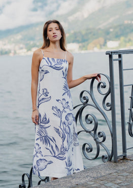 model wears a white and blue floral midi dress