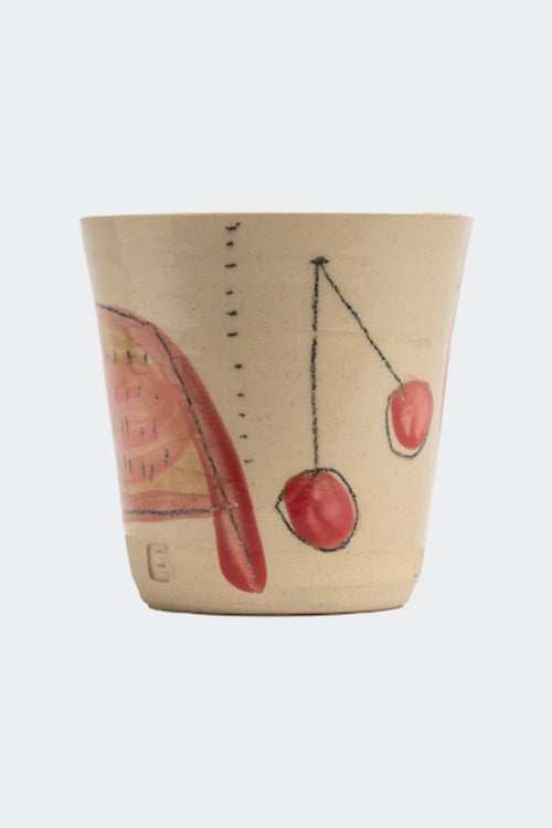 Beige ceramic cup with red cherry design on a white background