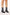 Black ankle boots with block heels worn by a person on a white background