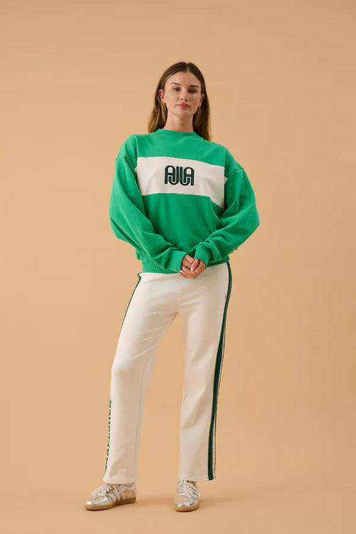 green and white sweater with text on front