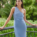 model wears a blue one shoulder midi dress