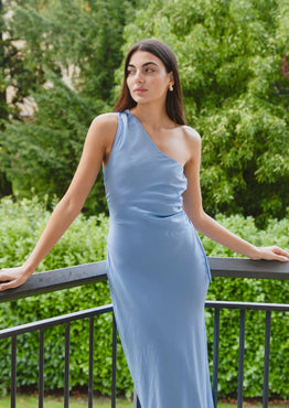 model wears a blue one shoulder midi dress