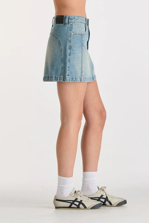 Woman wearing a blue denim mini skirt