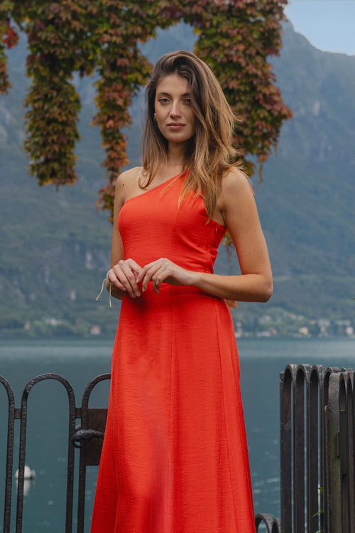 model wears a one shoulder red maxi dress