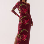 Woman wearing a burgundy dress with floral pattern on a white background