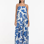 Woman wearing a blue floral dress on a white background