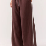 Brown wide-leg pants with a white stripe on a white background