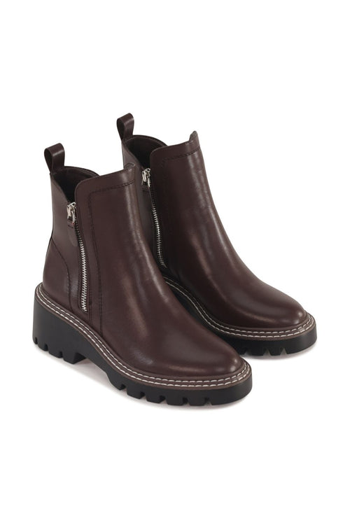Pair of brown leather boots with zippers on a white background