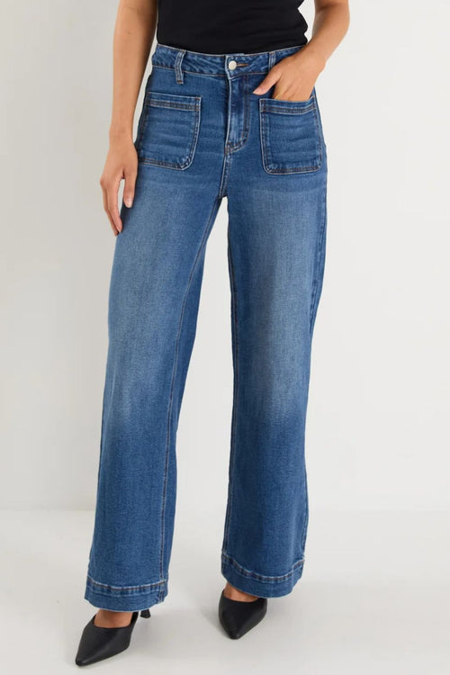Person wearing blue jeans on a white background