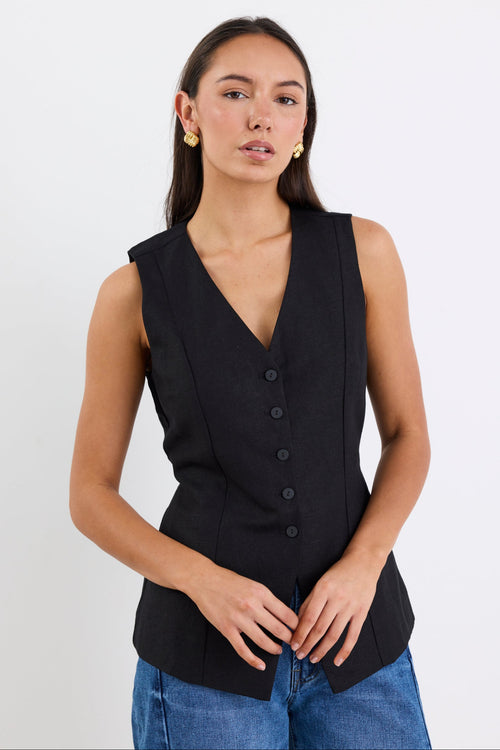 Woman wearing a black sleeveless vest on a white background