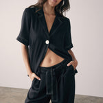 model wearing a black top with contrast stitching