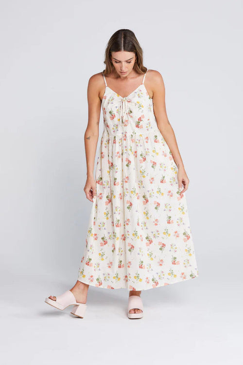 Woman wearing a floral cream long dress