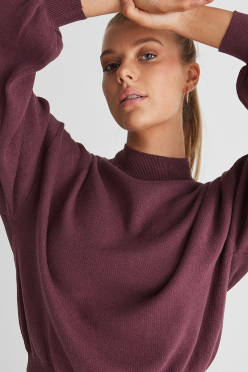 model wears a purple knit