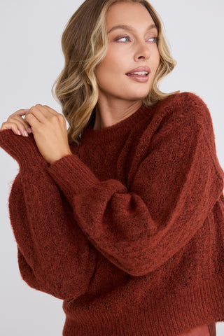 model wears a red knit