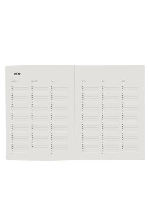 An open planner or calendar showing blank monthly writing pages with columns for day, weekday, event, place, and notes, photographed on a plain white background.