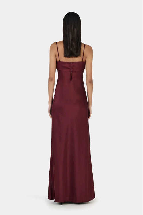 Model wears a burgundy event dress